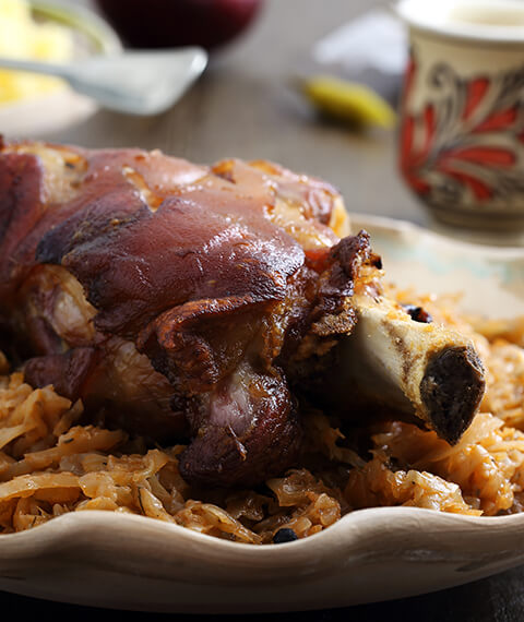Roast pork knuckle on a bed of braised Savoy cabbage